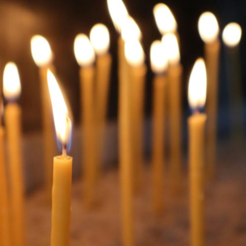 A serene arrangement of lit candles creating a warm ambiance indoors.